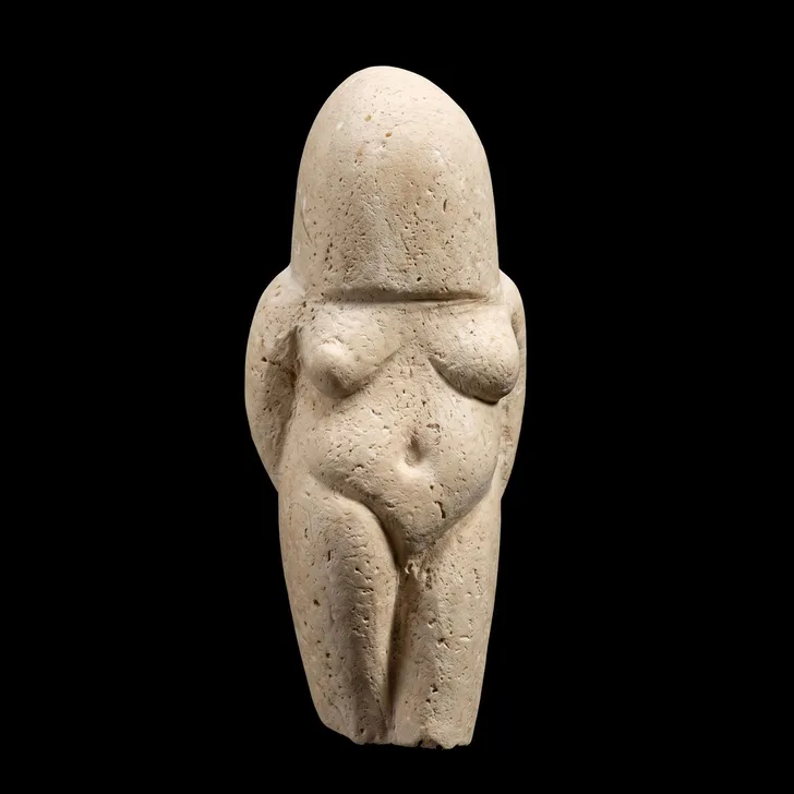 A carved stone female figure