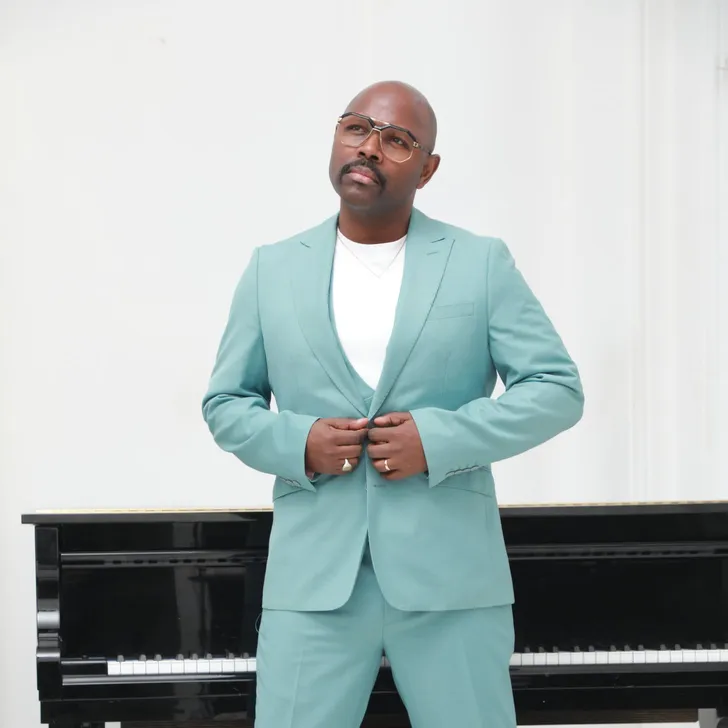 Mr Gee standing in front of a grand piano